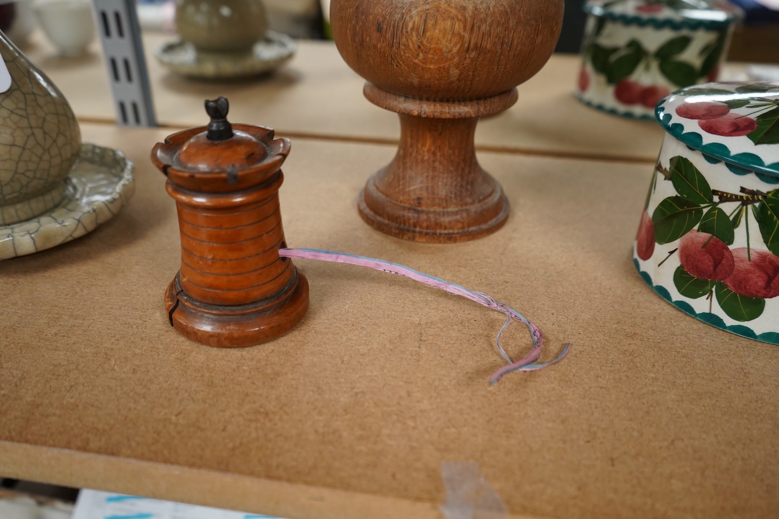 A 19th century treen tower tape measure and an oak goblet with provence label, 13cm